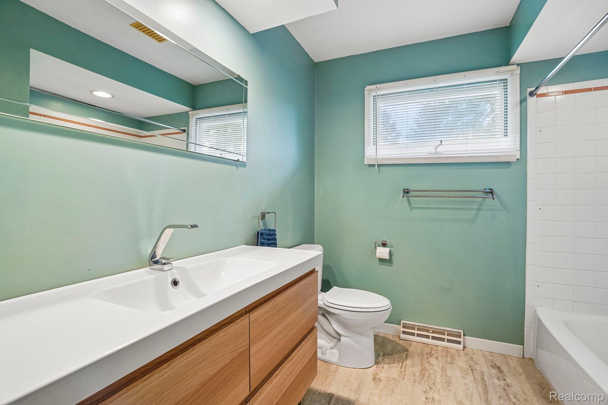 3981 South State Road Durand, MI 48429 - Photo 12 of 33 Wood-finish vanity with integrated rectangular sink and polished chrome faucet