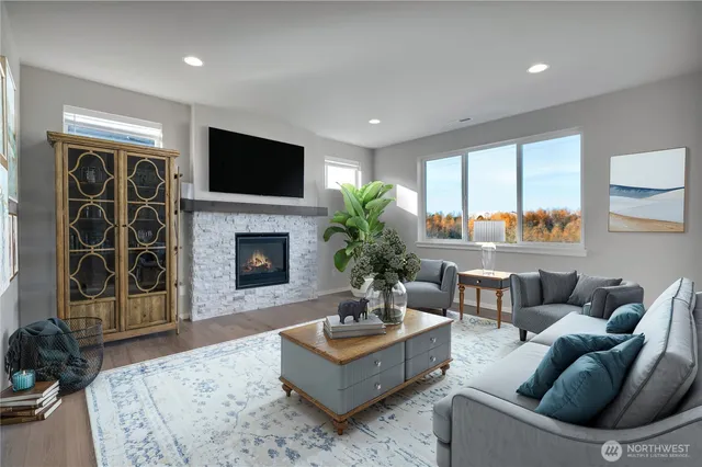 a living room with furniture a flat screen tv and a fireplace