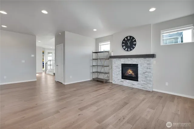 a view of an empty room with a fireplace and a window