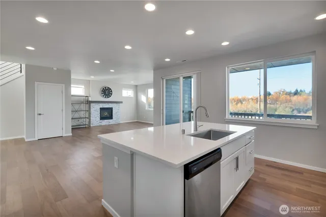 a open kitchen with stainless steel appliances granite countertop a sink and a stove