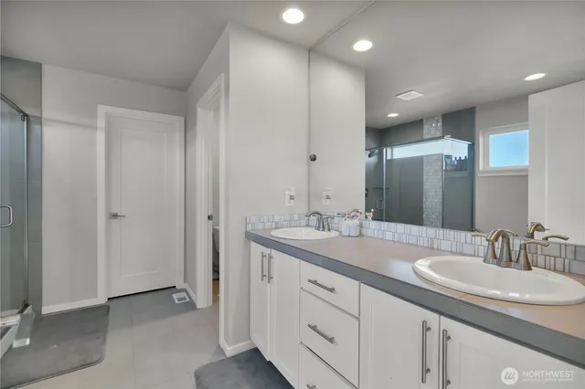 a bathroom with a double vanity sink and a mirror