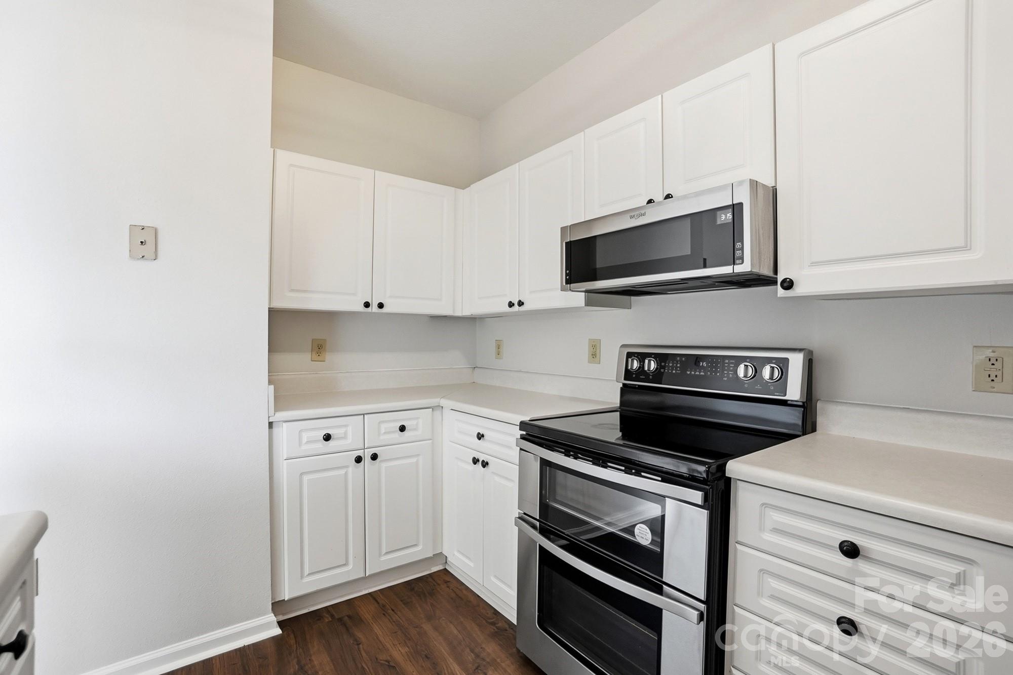 711 Stone Village Drive Fort Mill, SC 29708 - Photo 22 of 46 a kitchen with cabinets appliances and a wooden floor