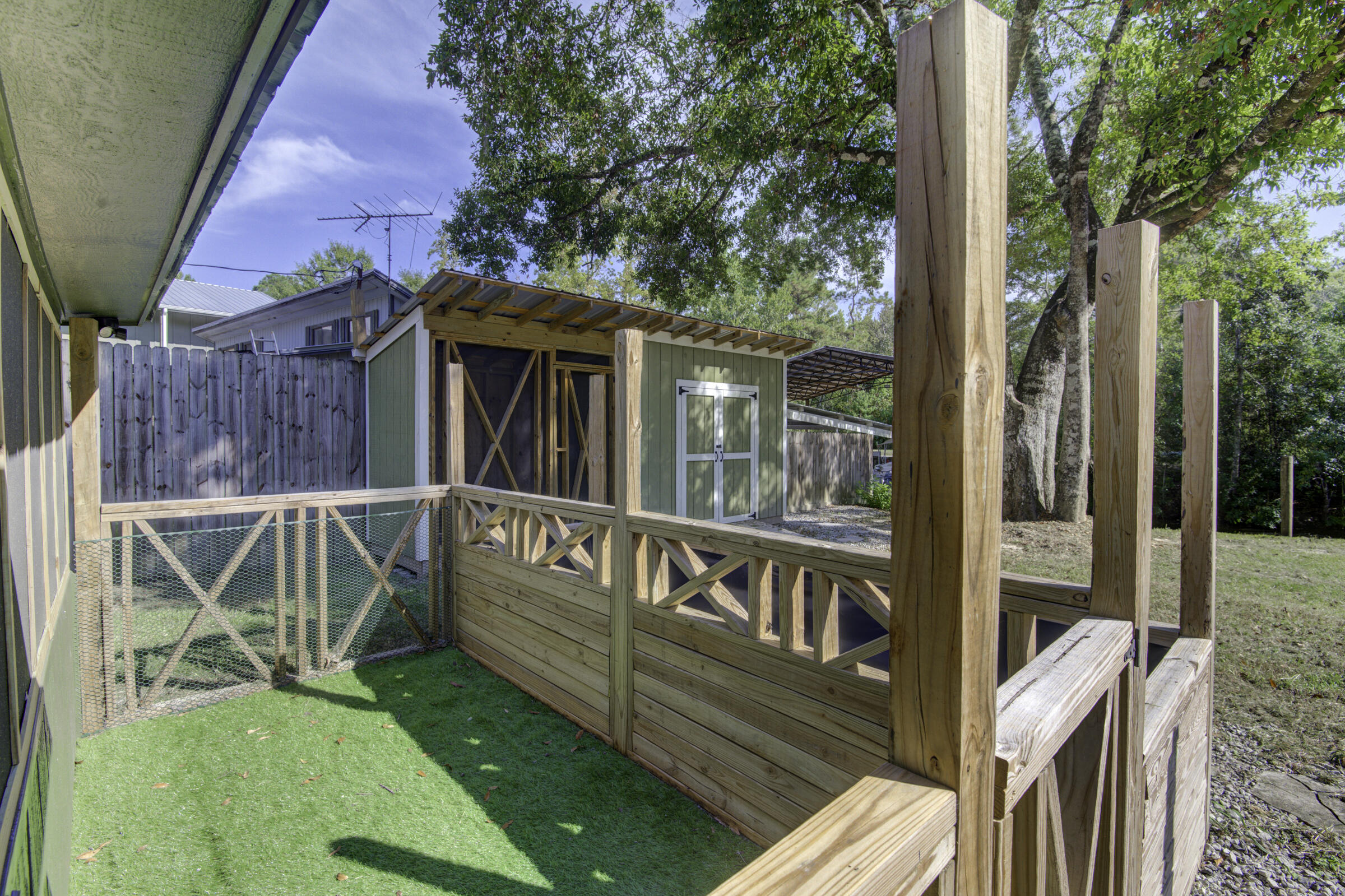 85 Our Street Vernon, FL 32462 - Photo 20 of 66 a view of a deck with chairs and a yard with wooden fence