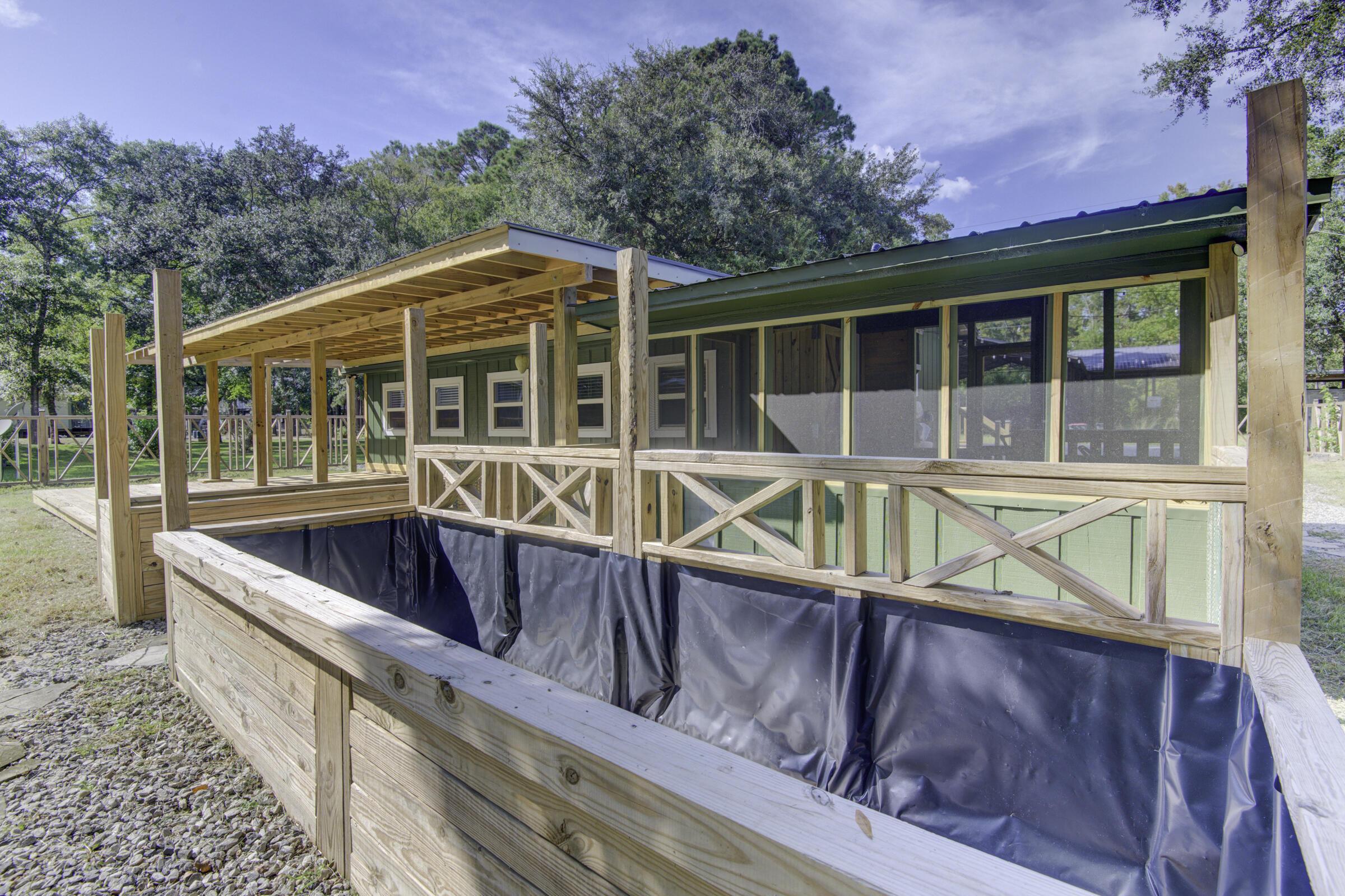 85 Our Street Vernon, FL 32462 - Photo 24 of 66 a view of a house with wooden deck and furniture