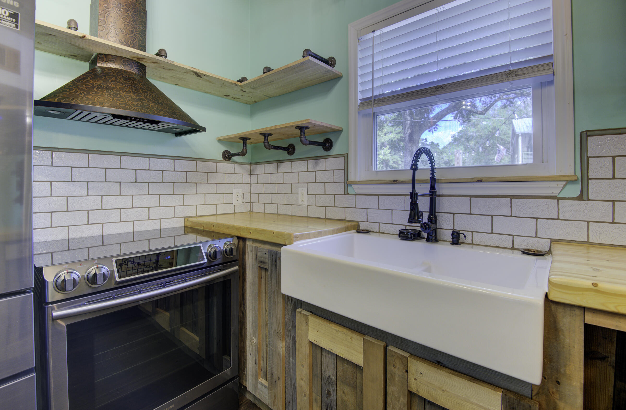 85 Our Street Vernon, FL 32462 - Photo 41 of 66 a kitchen with a sink a stove and a microwave
