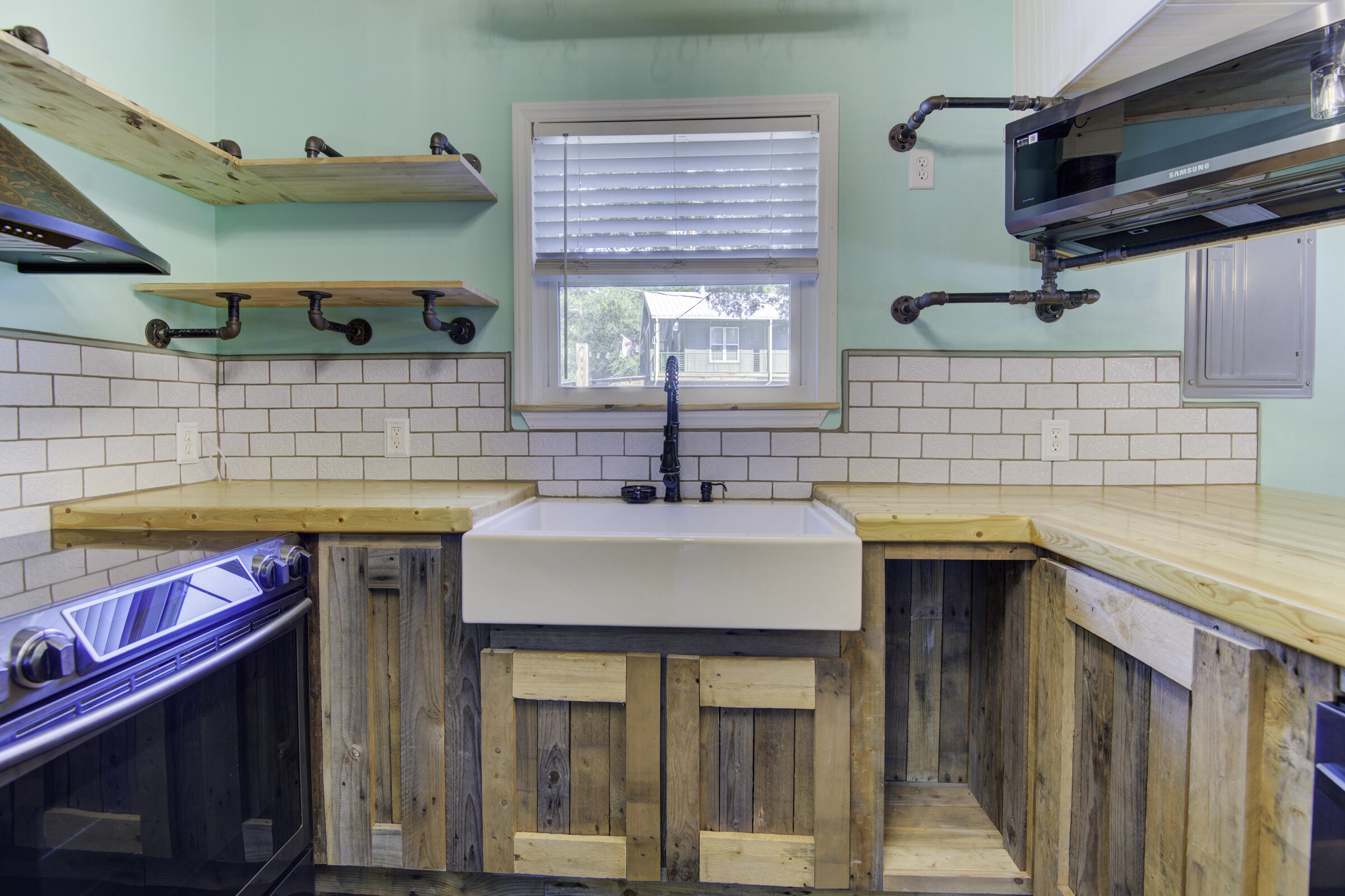 85 Our Street Vernon, FL 32462 - Photo 43 of 66 a kitchen with stainless steel appliances wooden cabinets a sink and a stove