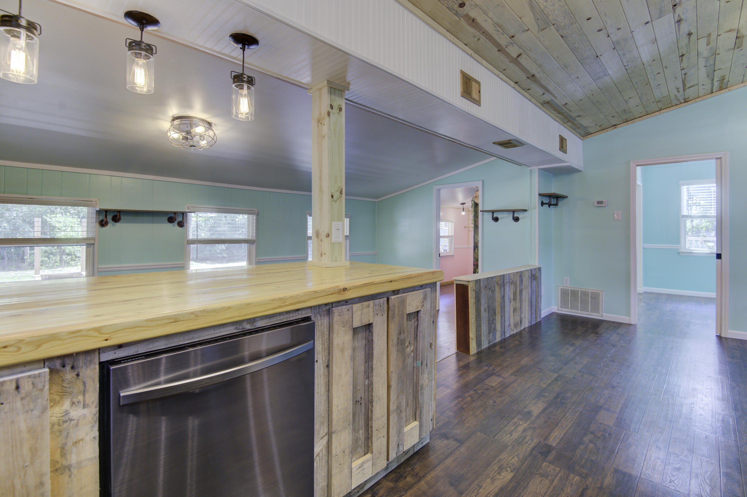 85 Our Street Vernon, FL 32462 - Photo 45 of 66 a kitchen with stainless steel appliances granite countertop a sink a stove top oven a wooden floor and potted plant