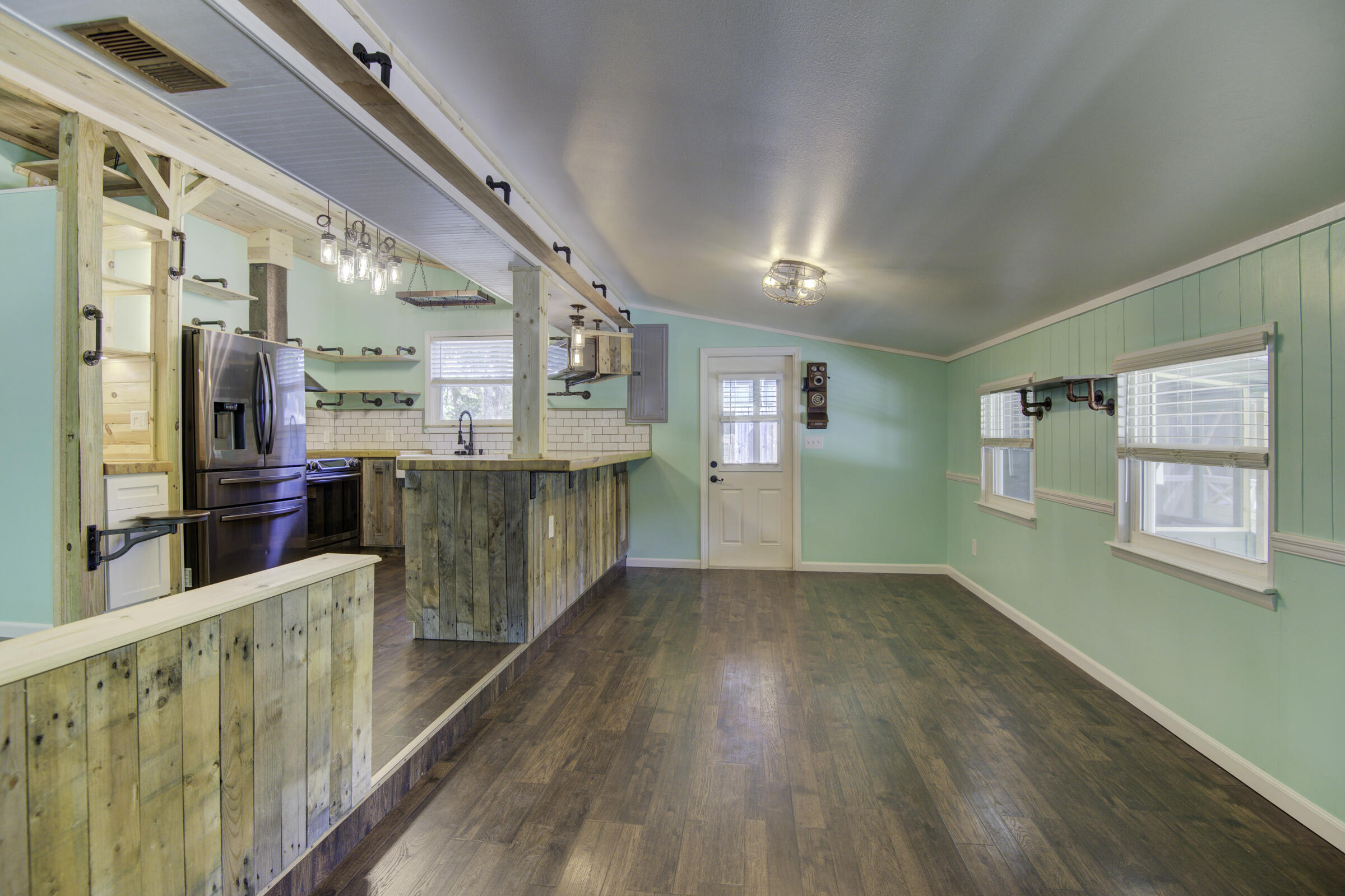 85 Our Street Vernon, FL 32462 - Photo 47 of 66 a view of a kitchen with an empty room and wooden floor