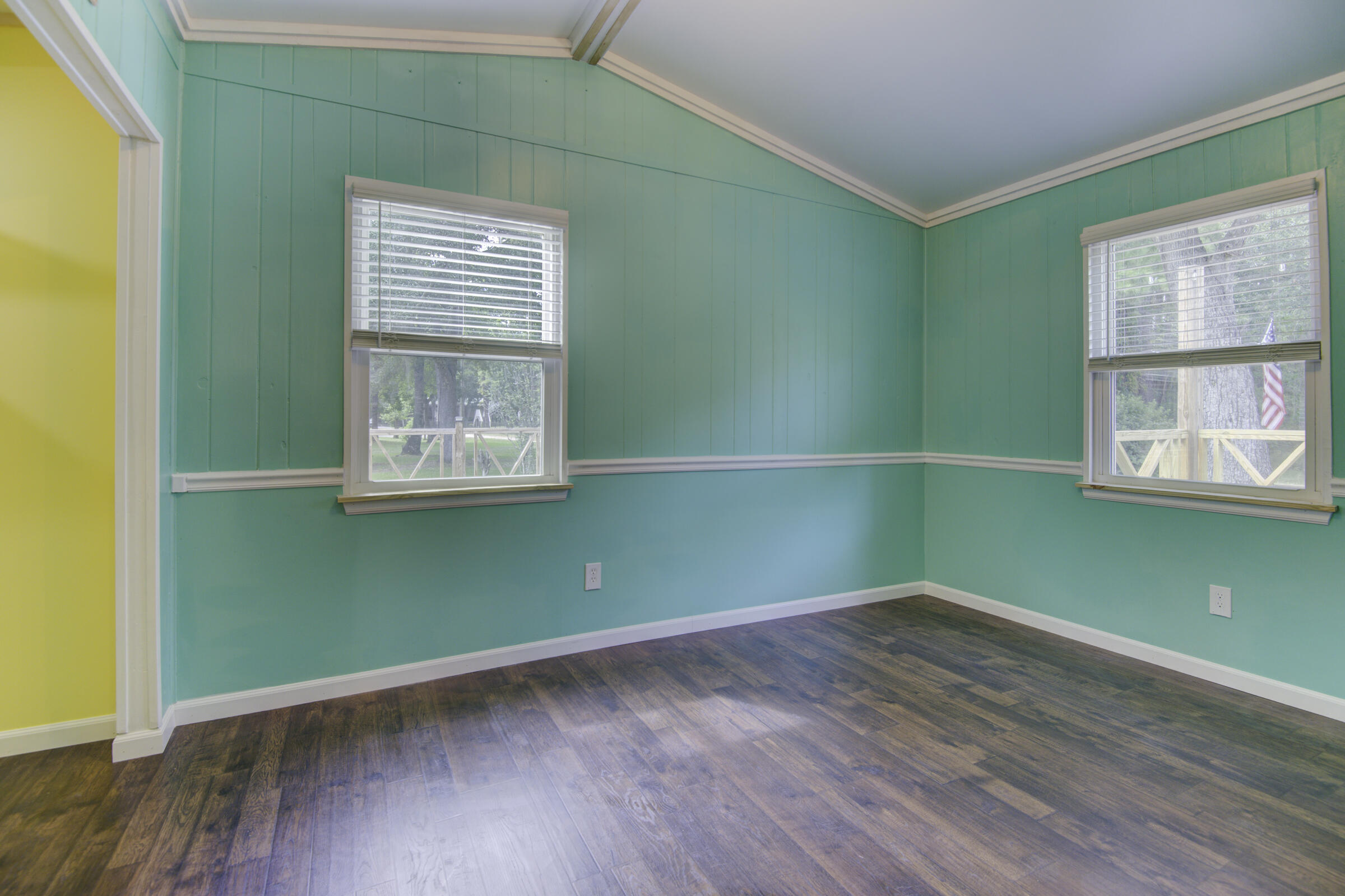 85 Our Street Vernon, FL 32462 - Photo 58 of 66 an empty room with wooden floor and windows