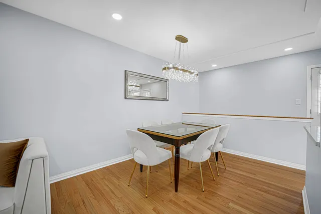 a view of a room with furniture and wooden floor