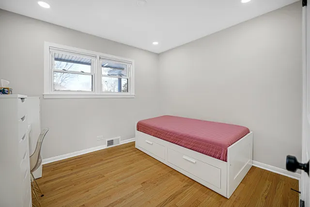 a room with a bed and a dresser