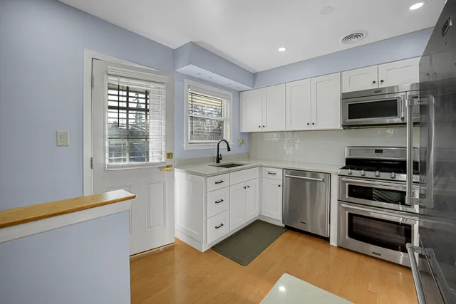 a kitchen with stainless steel appliances a stove sink and microwave