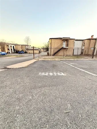 a view of building with car parked