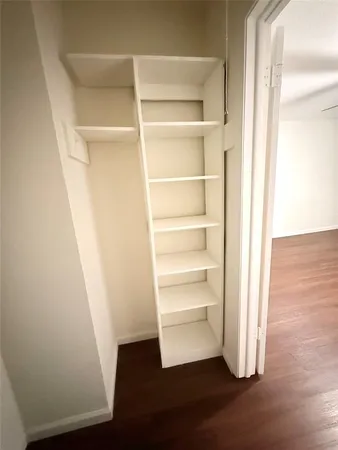 a view of walk in closet with empty racks