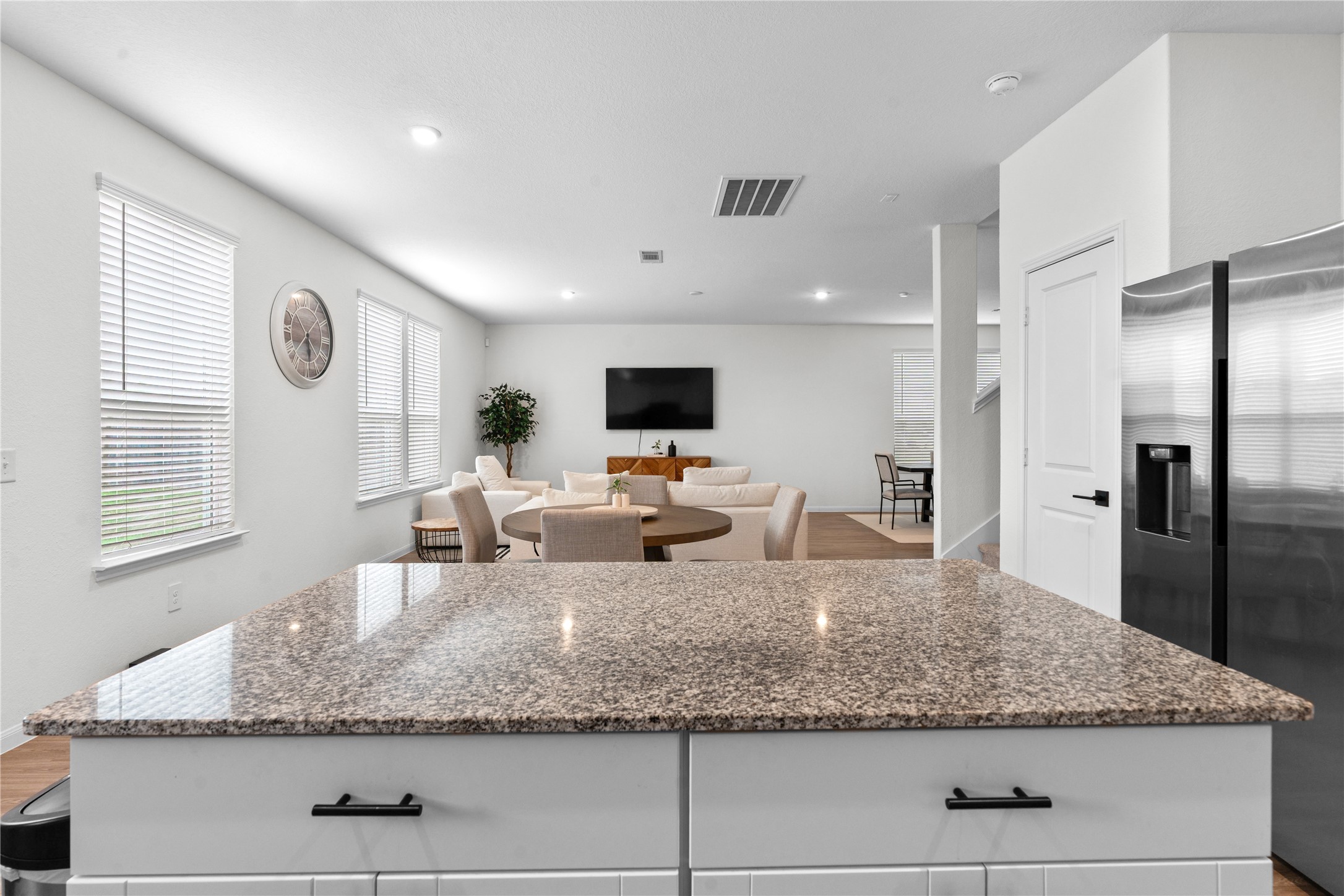 Kitchen island overlooks the main living area, refrigerator included