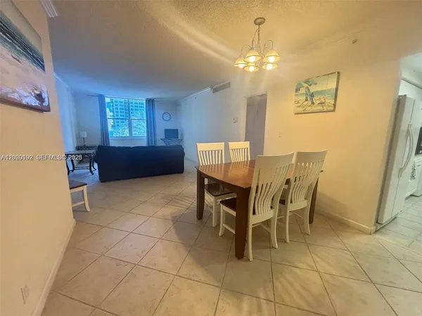 a dining room with furniture and chandelier