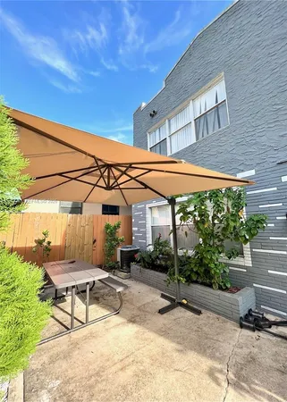 a building outdoor space with patio furniture and potted plants