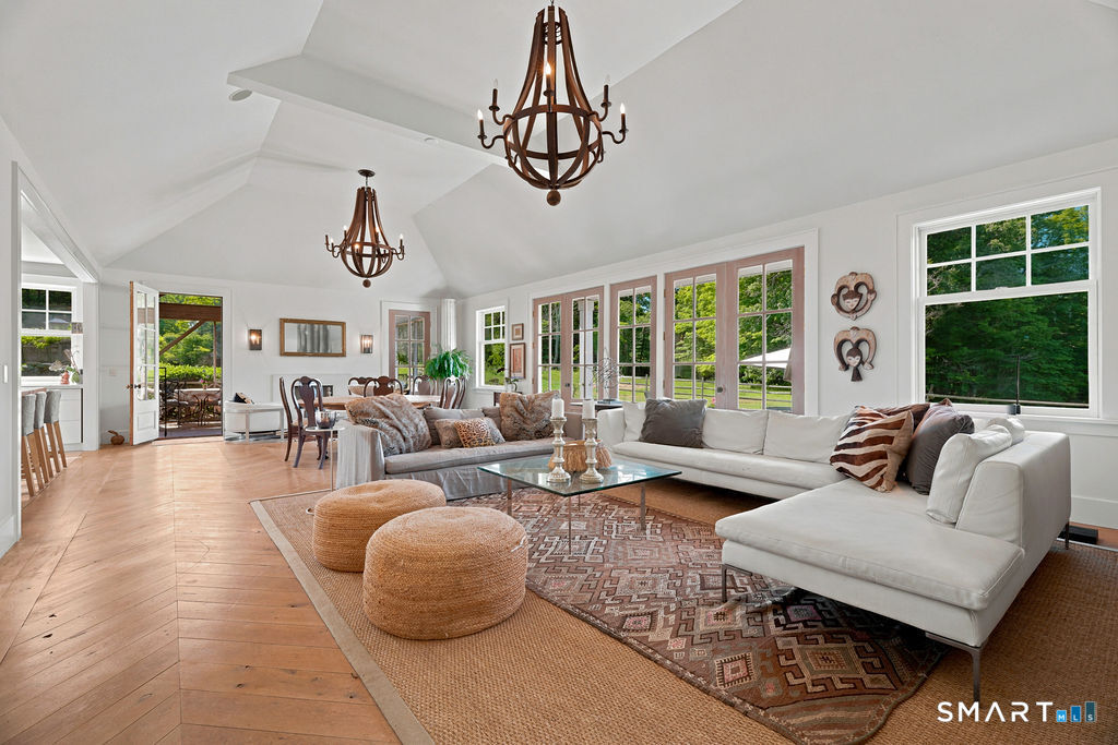 261-1 Grassy Hill Road Lyme, CT 06371 - Photo 7 of 40 The stunning great room serves as the heart of the home, where French doors open to sweeping views and to the screened porch.