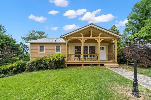 a view of a house with a yard and plants