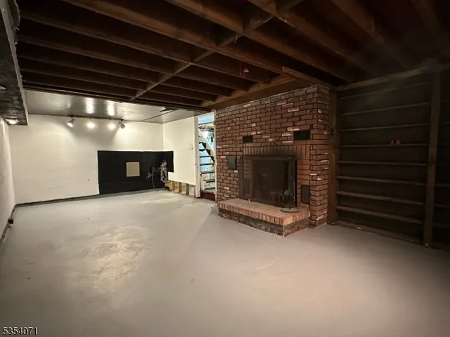 a view of an empty room with a fireplace