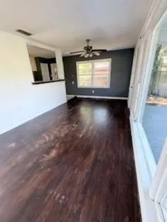 wooden floor in an empty room with a window