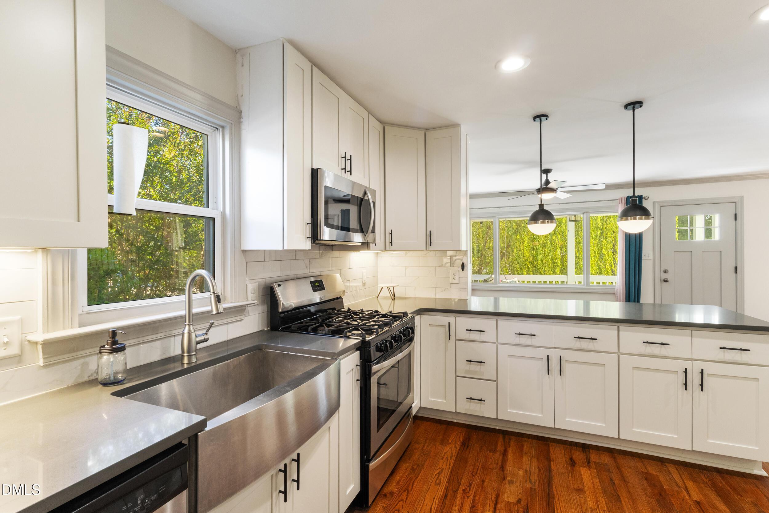 200 Lincoln Court Raleigh, NC 27610 - Photo 12 of 45 a kitchen with granite countertop a sink a counter space appliances and cabinets