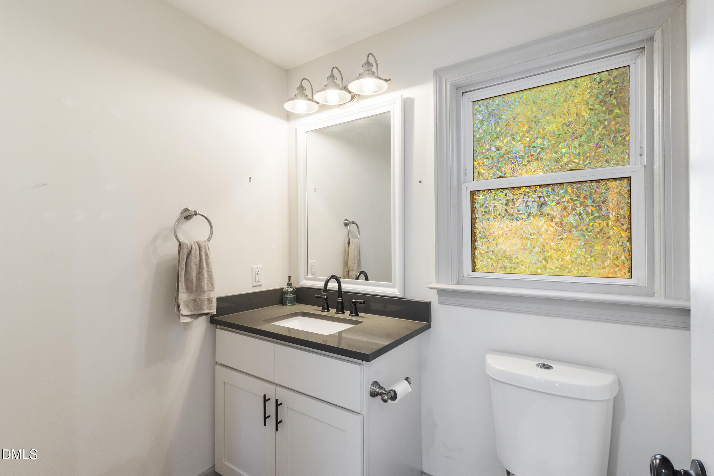 200 Lincoln Court Raleigh, NC 27610 - Photo 14 of 45 a bathroom with a sink and a mirror