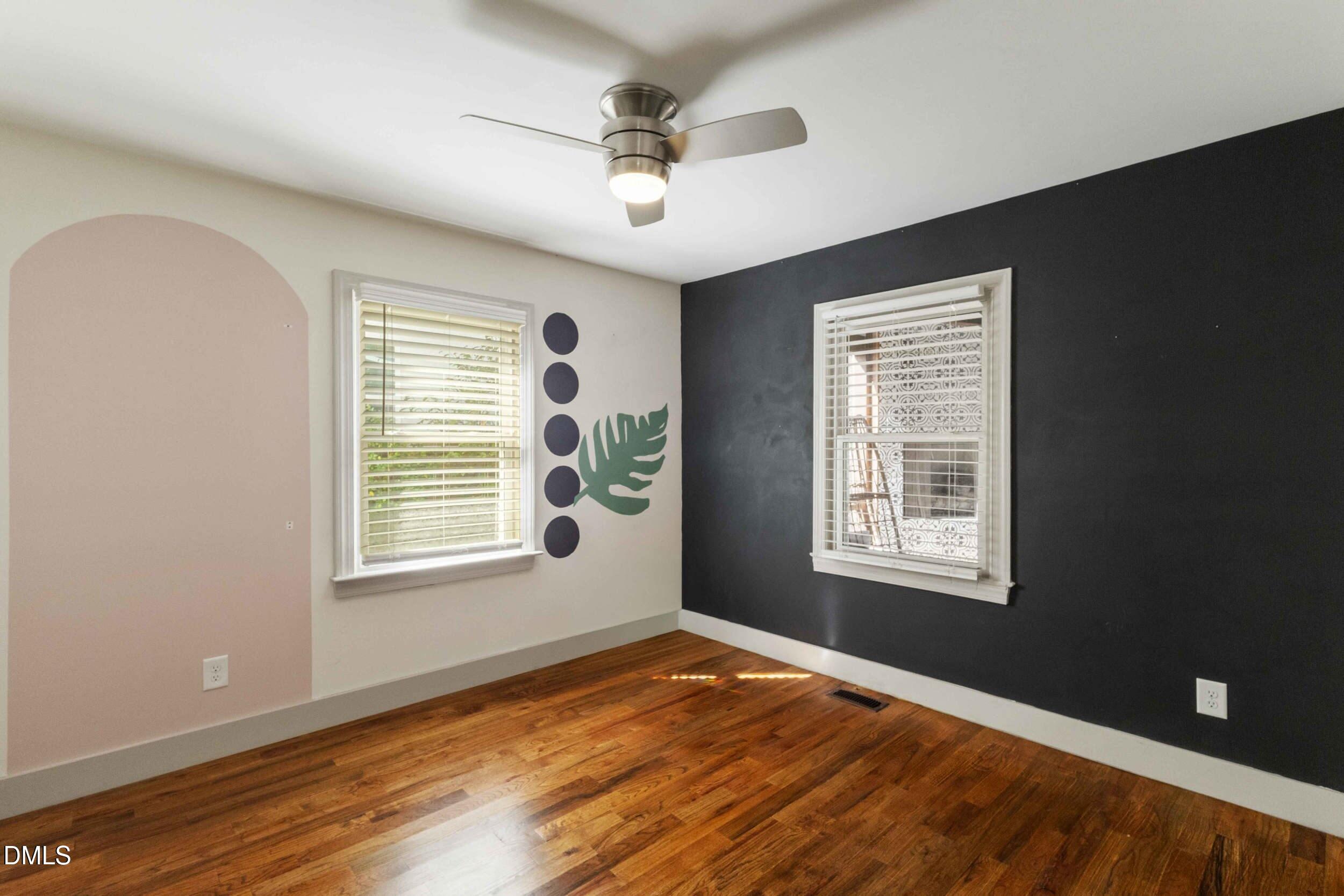 200 Lincoln Court Raleigh, NC 27610 - Photo 15 of 45 a view of an empty room with a window and wooden floor