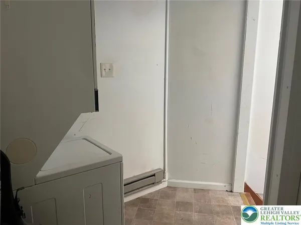 a view of a hallway with furniture and a window