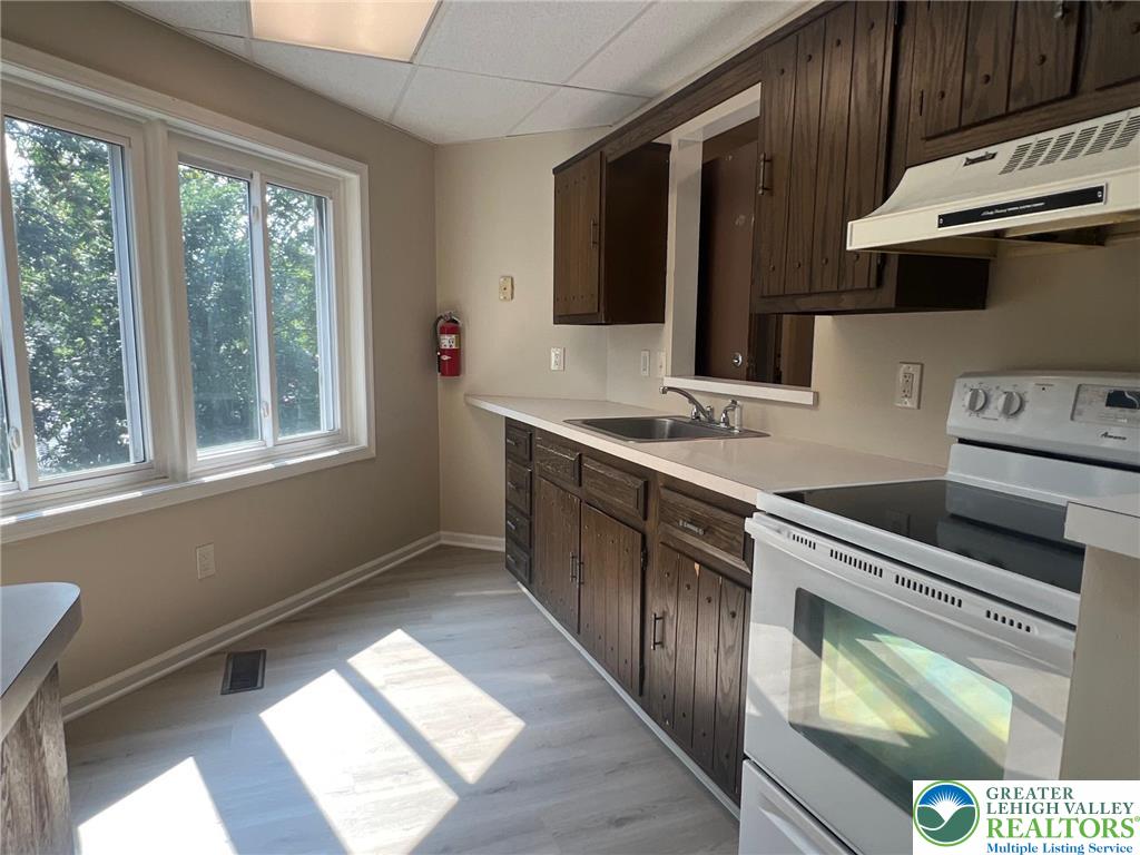 934 Bank Street Emmaus, PA 18049 - Photo 8 of 17 a kitchen with stainless steel appliances granite countertop a sink stove and cabinets