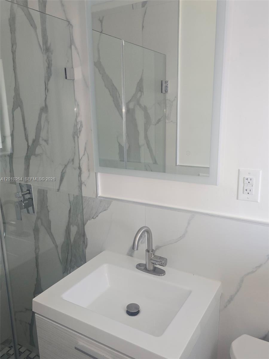 3300 Southeast 6th Street, Unit 2 Pompano Beach, FL 33062 - Photo 5 of 7 a bathroom with a sink and a mirror
