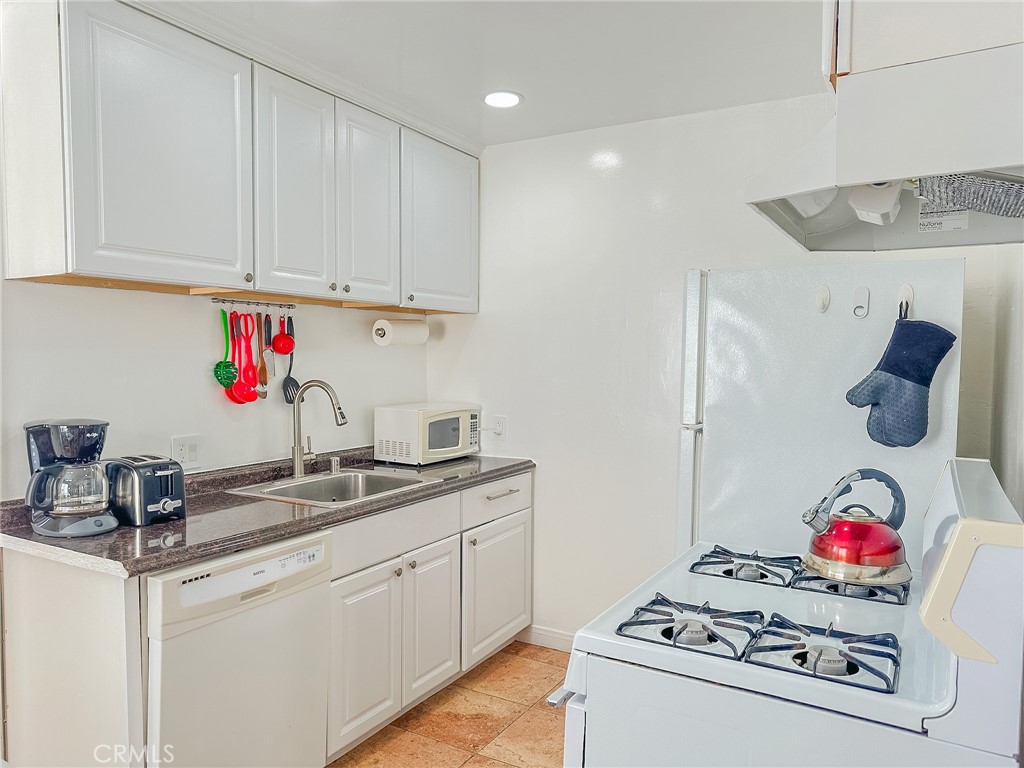 33922 Malaga Drive Dana Point, CA 92629 - Photo 12 of 22 a kitchen with white cabinets and white appliances
