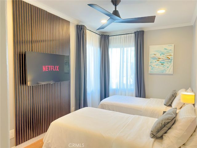 a bedroom with a bed and a chandelier