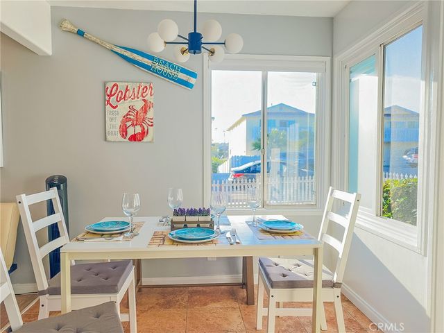 a dining room with furniture a chandelier and wooden floor
