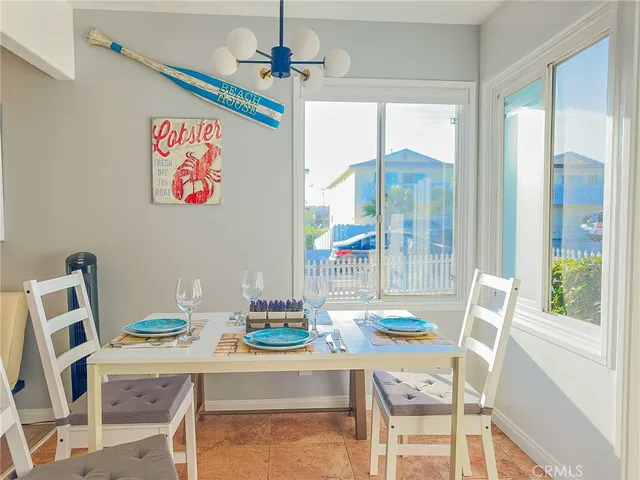a dining room with furniture a chandelier and wooden floor