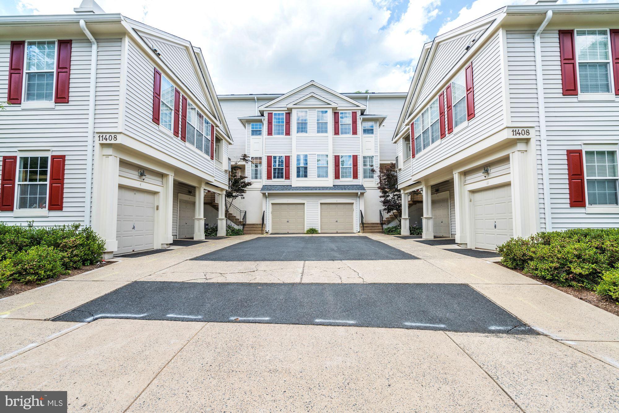 11408 Gate Hill Place, Unit 116 Reston, VA 20194 - Photo 1 of 28 a front view of a building with a yard