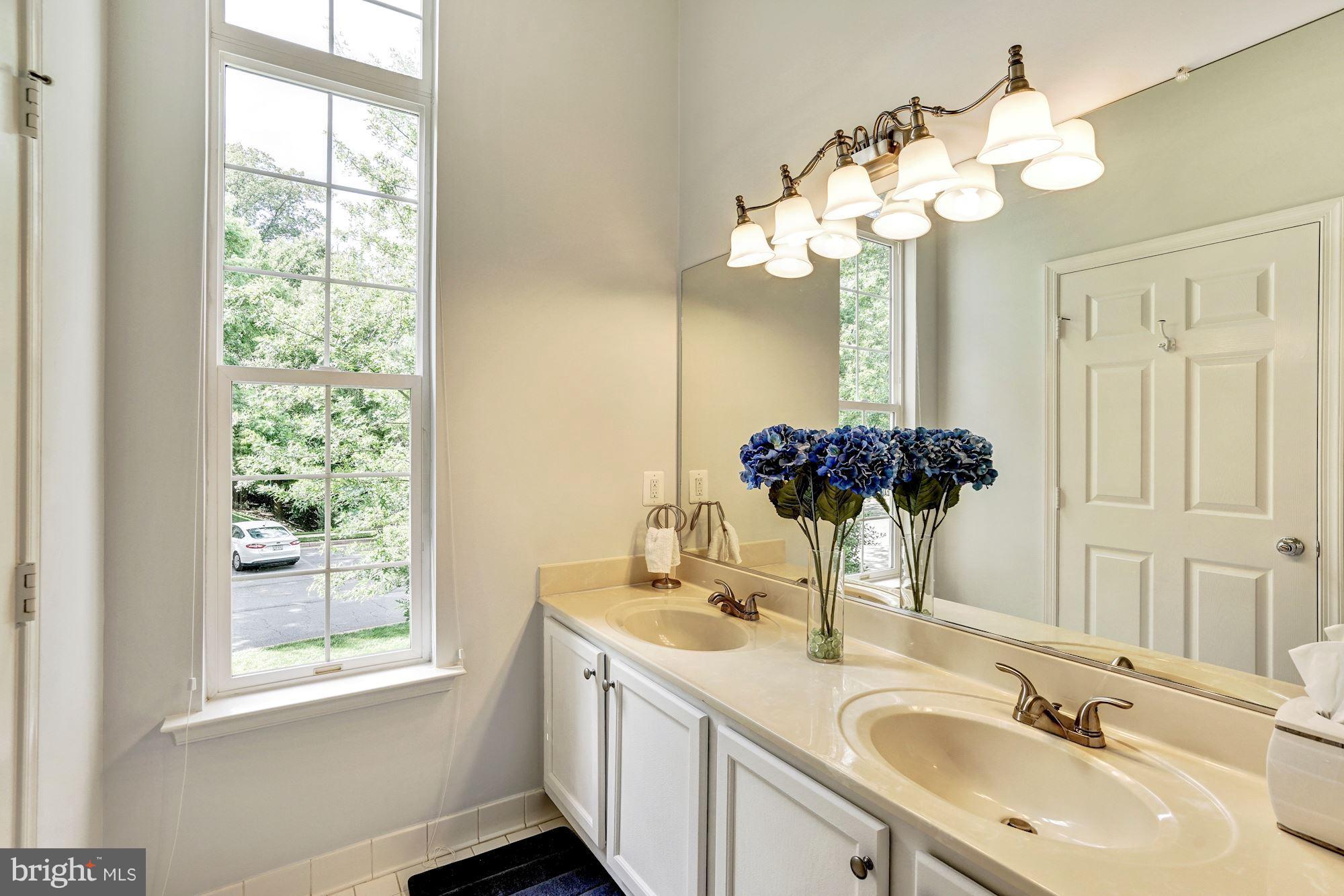 11408 Gate Hill Place, Unit 116 Reston, VA 20194 - Photo 12 of 28 a bathroom with a sink vanity granite and a mirror