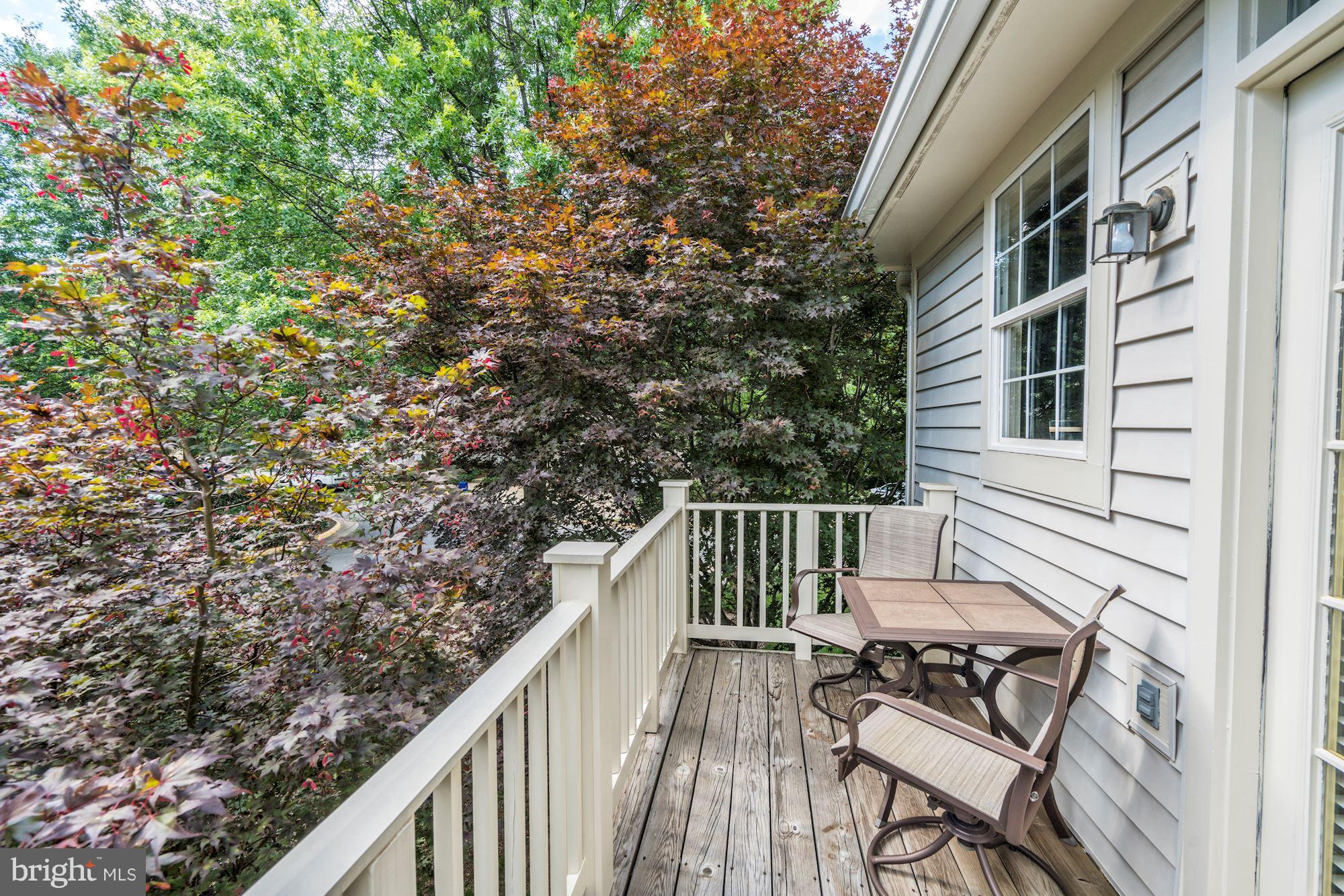 11408 Gate Hill Place, Unit 116 Reston, VA 20194 - Photo 22 of 28 a view of balcony with wooden floor and fence