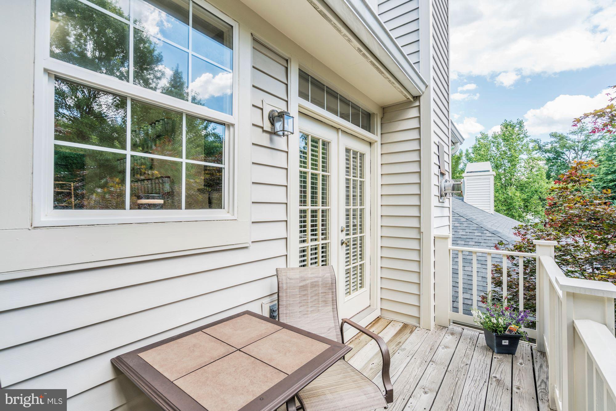 11408 Gate Hill Place, Unit 116 Reston, VA 20194 - Photo 23 of 28 a view of a house with a large window and wooden floor