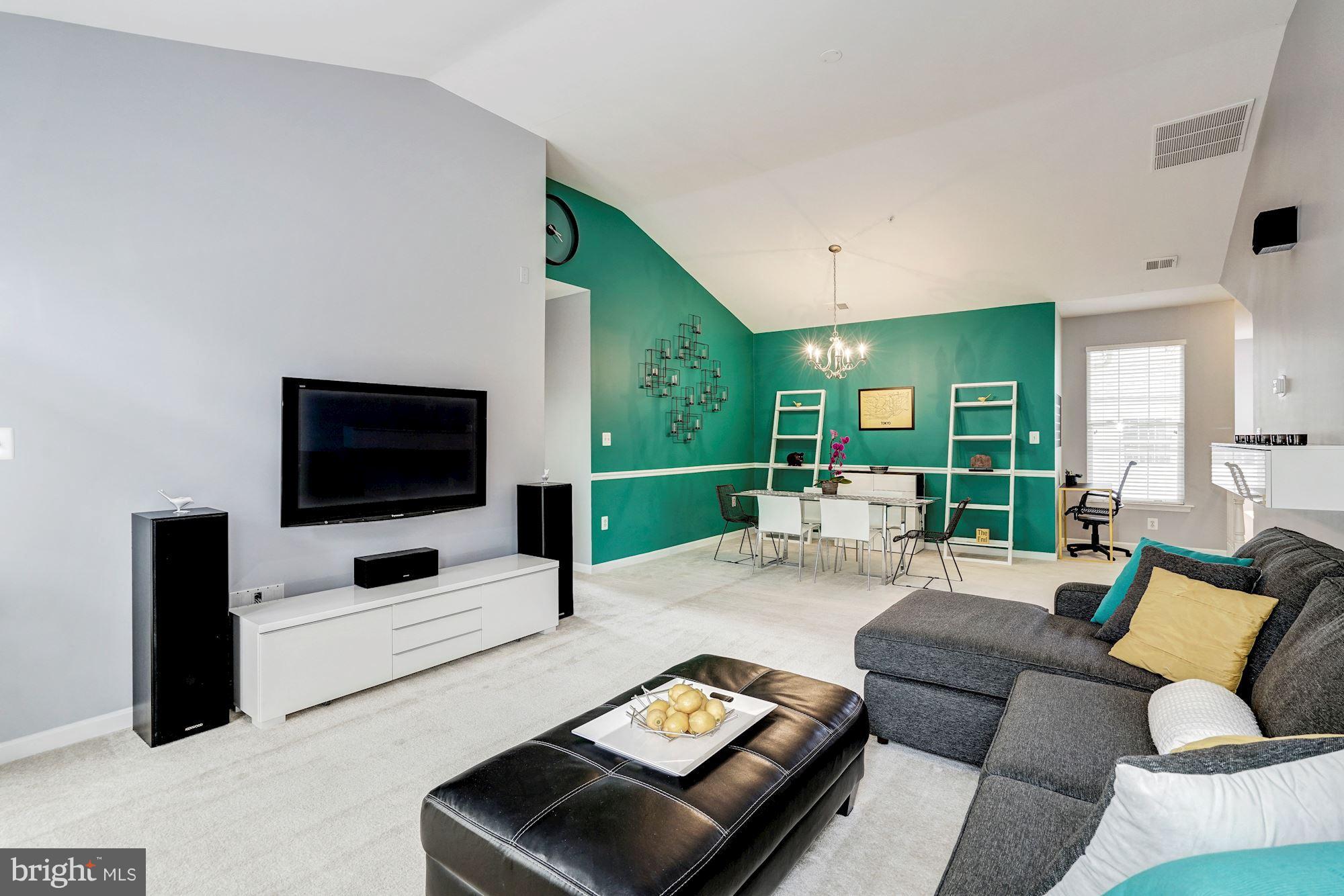 11408 Gate Hill Place, Unit 116 Reston, VA 20194 - Photo 6 of 28 a living room with furniture and a flat screen tv