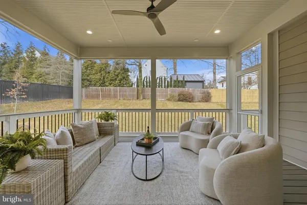 a living room with furniture and floor to ceiling window