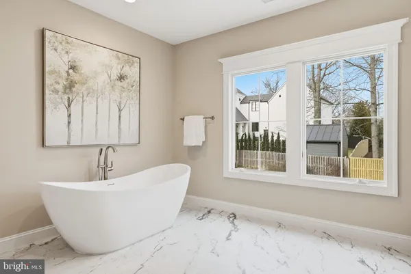 a white bath tub sitting next to a window