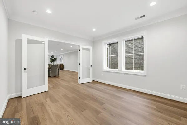 a view of empty room with wooden floor and cabinet