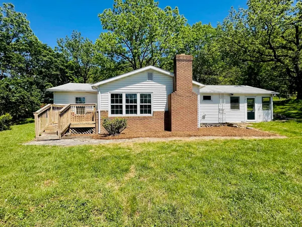 a front view of a house with a yard table and chairs