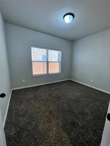 an empty room with a empty space and windows