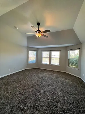 a view of an empty room with windows