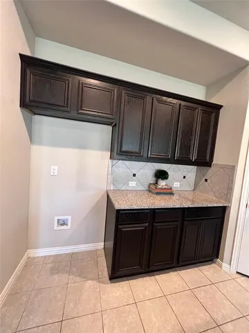 a view of kitchen with stainless steel appliances granite countertop a sink and cabinets