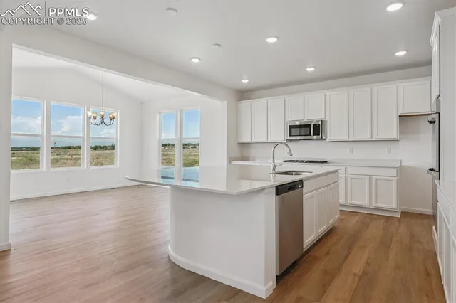 a kitchen with wooden floors and white appliances