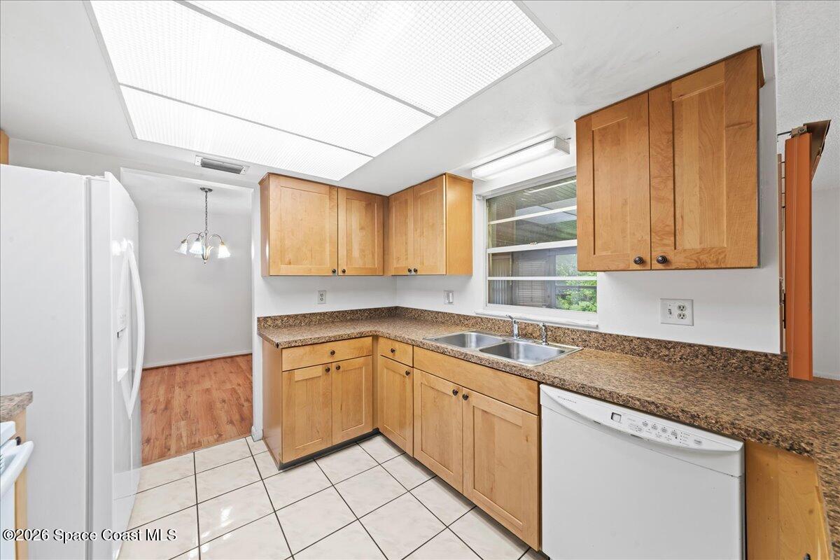 2066 Acacia Street Northeast Palm Bay, FL 32905 - Photo 13 of 28 a kitchen with a sink cabinets and window