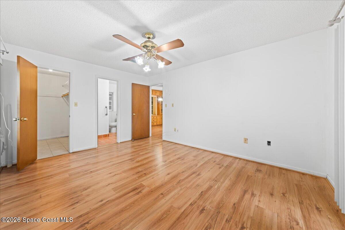 2066 Acacia Street Northeast Palm Bay, FL 32905 - Photo 16 of 28 a view of an empty room with wooden floor